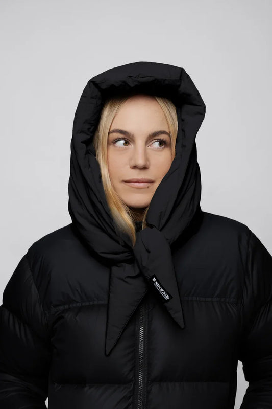 Black vegan puffer jacket with hood made from recycled materials, styled with hood up. - The New Orchard - Charcoal Black