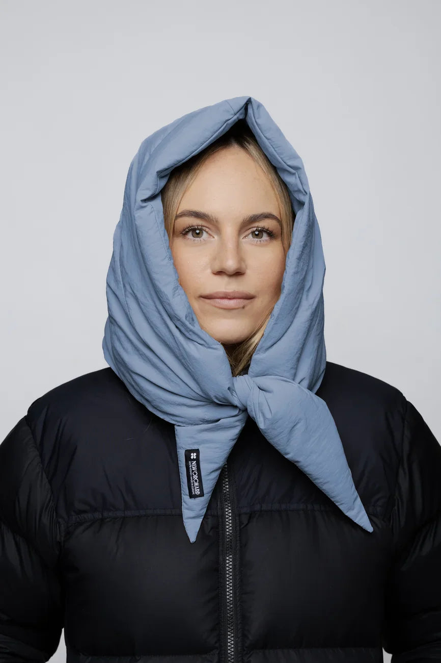 Sky blue vegan capuche made from recycled materials, styled over black puffer jacket. - The New Orchard - Sky Blue
