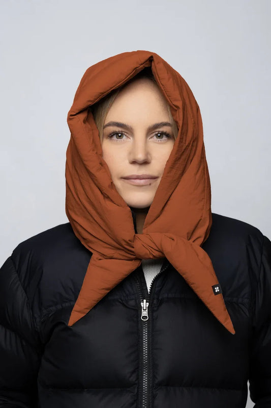 Vegan cinnamon-colored winter capuche made from recycled materials, styled over a black puffer jacket. - The New Orchard - Fresh Cinnamon