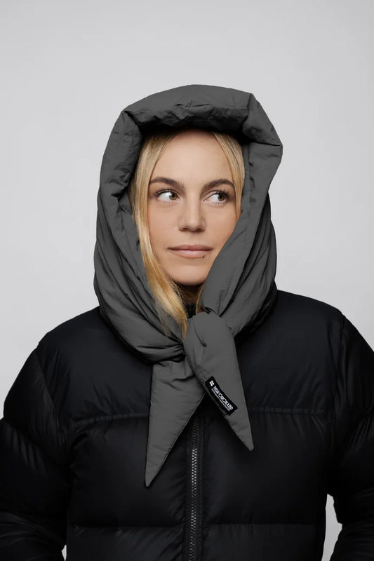Light grey vegan winter capuche with tie detail made from recycled materials worn with black puffer jacket. - The New Orchard - Light Grey