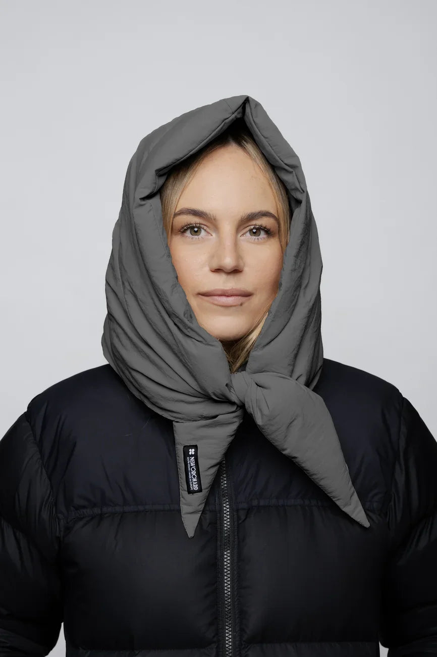 Grey padded vegan winter capuche made from recycled materials worn over a black jacket. - The New Orchard - Light Grey