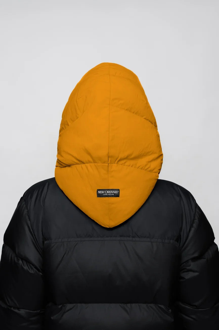 Amber yellow vegan winter capuche made from recycled materials on black puffer jacket back view. - The New Orchard - Amber Yellow