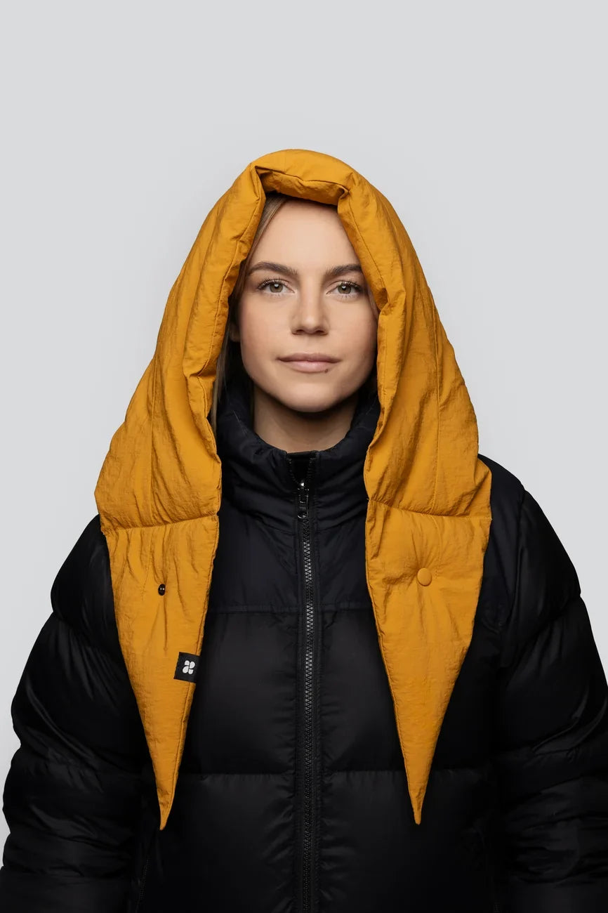 Amber yellow vegan puffer hood made from recycled materials over black jacket. - The New Orchard - Amber Yellow