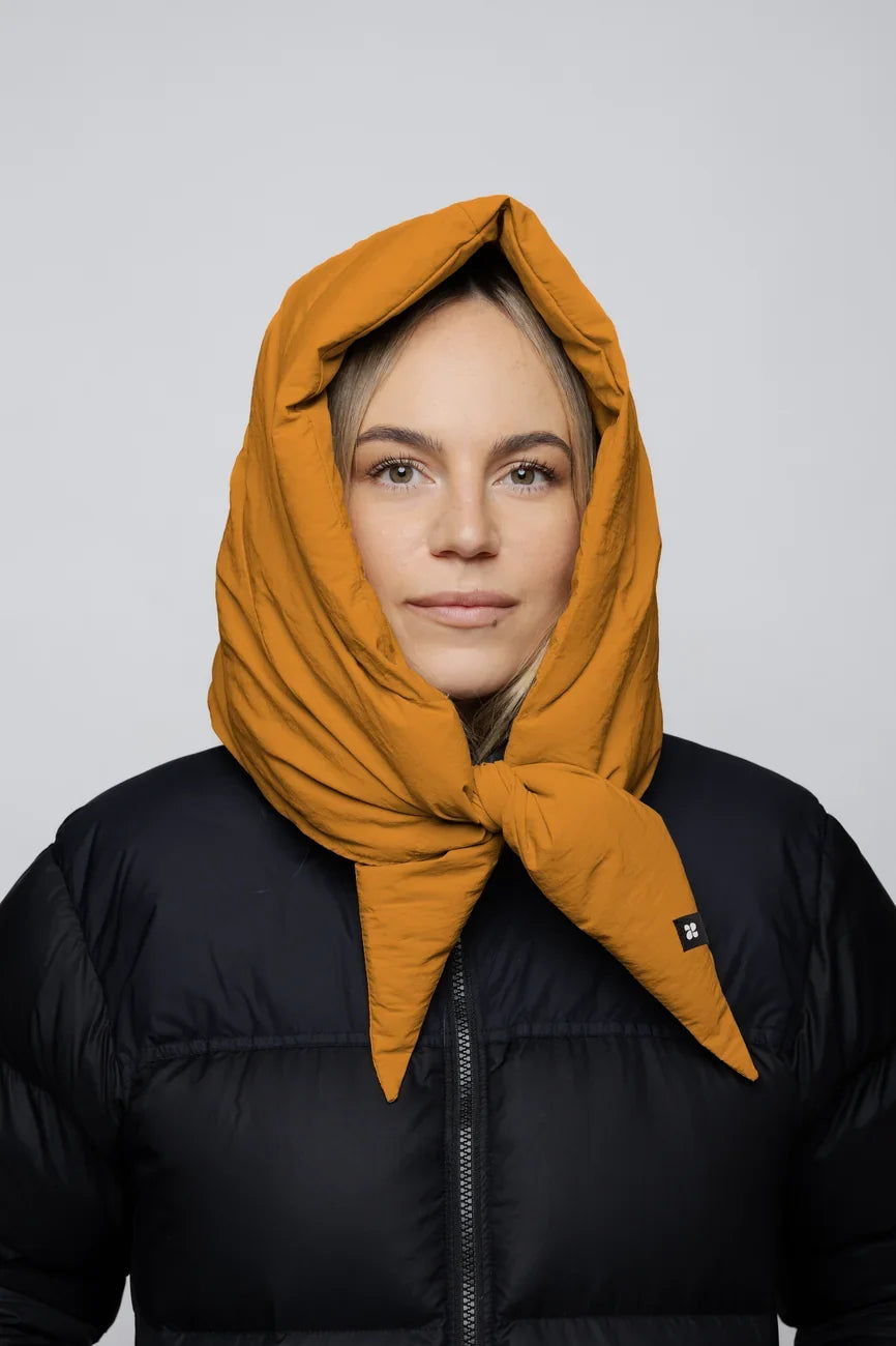 Amber yellow vegan hood made from recycled materials, styled over black puffer jacket. - The New Orchard - Amber Yellow