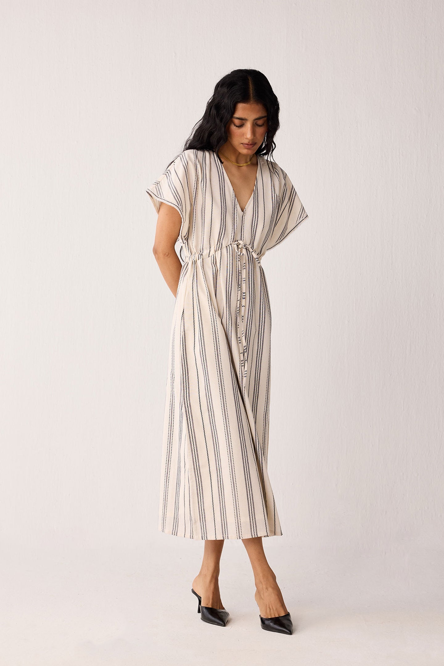 Woman wearing a striped dress on a white background