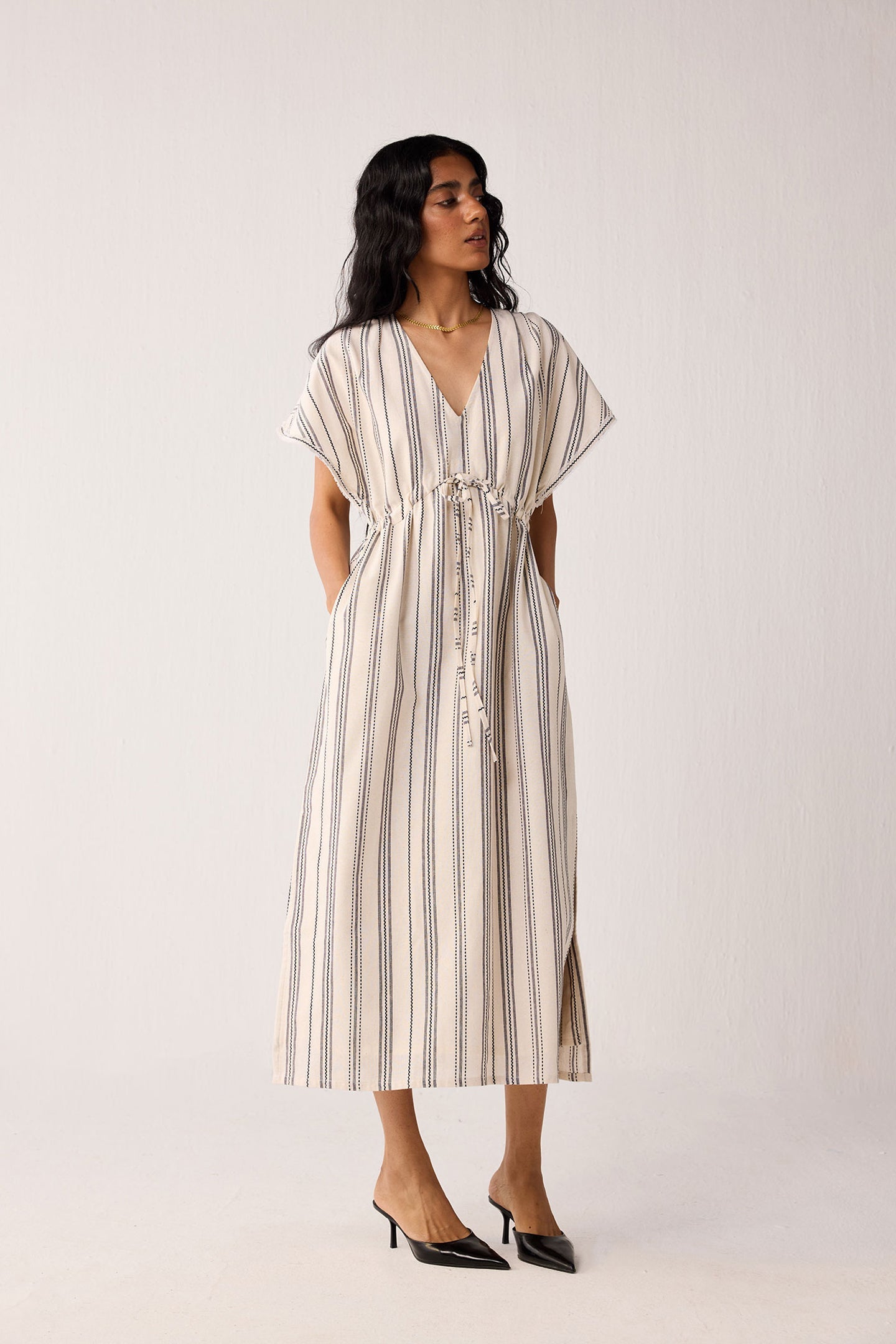 Woman wearing a striped dress on a white background