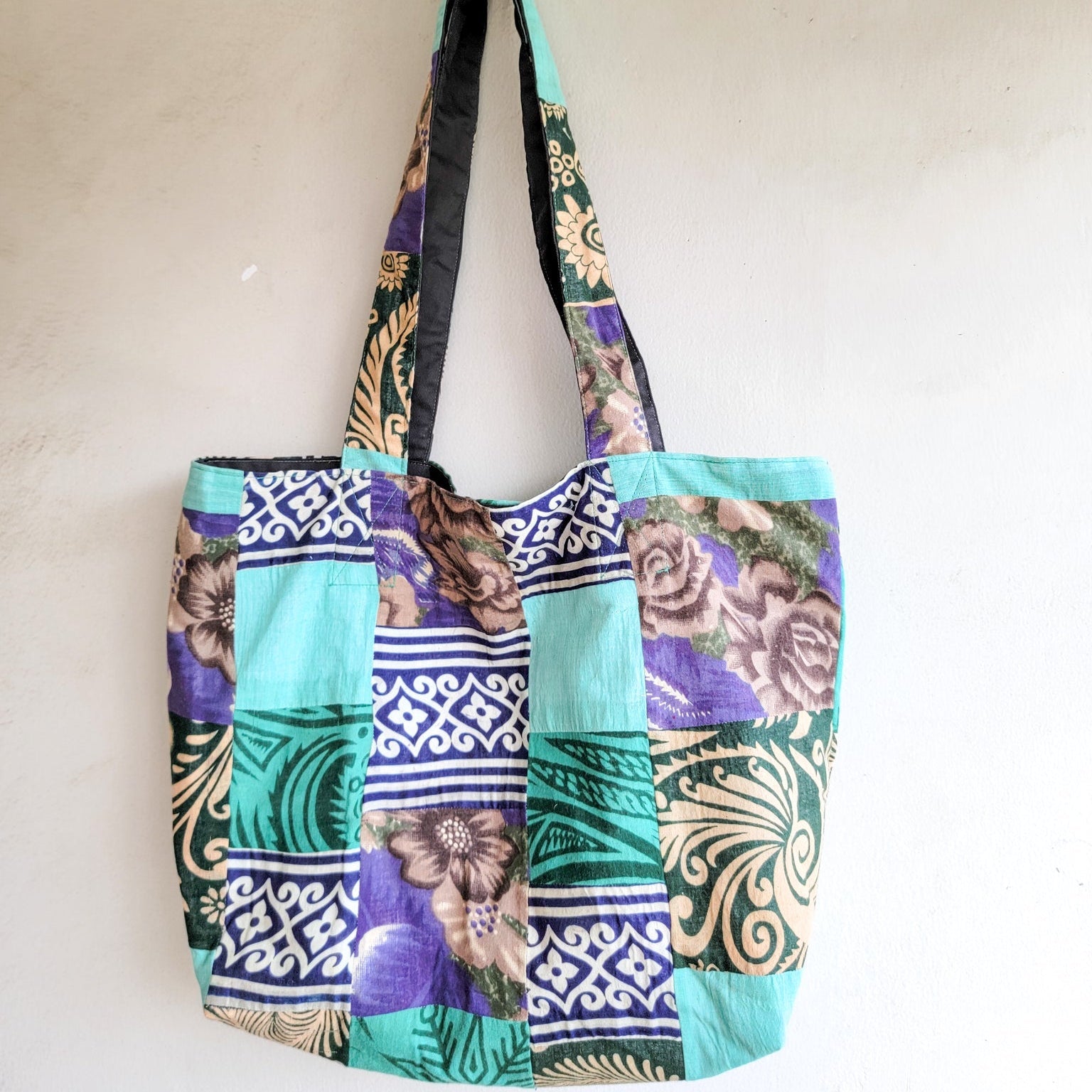 Colorful patterned tote bag on a plain background