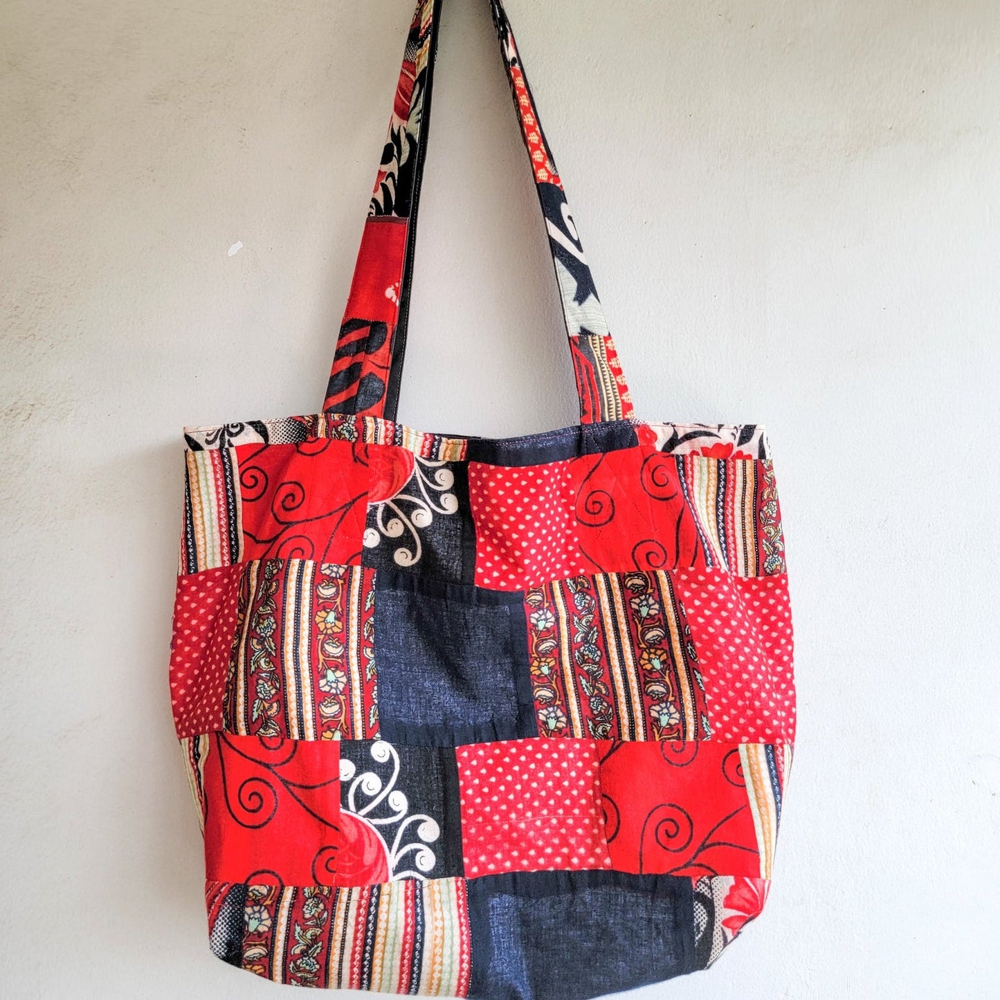 Multicolored patchwork tote bag on a white background