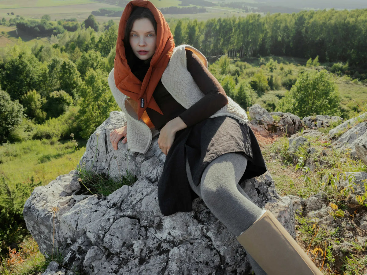 Woman wearing vegan cinnamon-colored hooded capuche made from recycled materials, styled with layered neutral outfit. - The New Orchard - Fresh Cinnamon