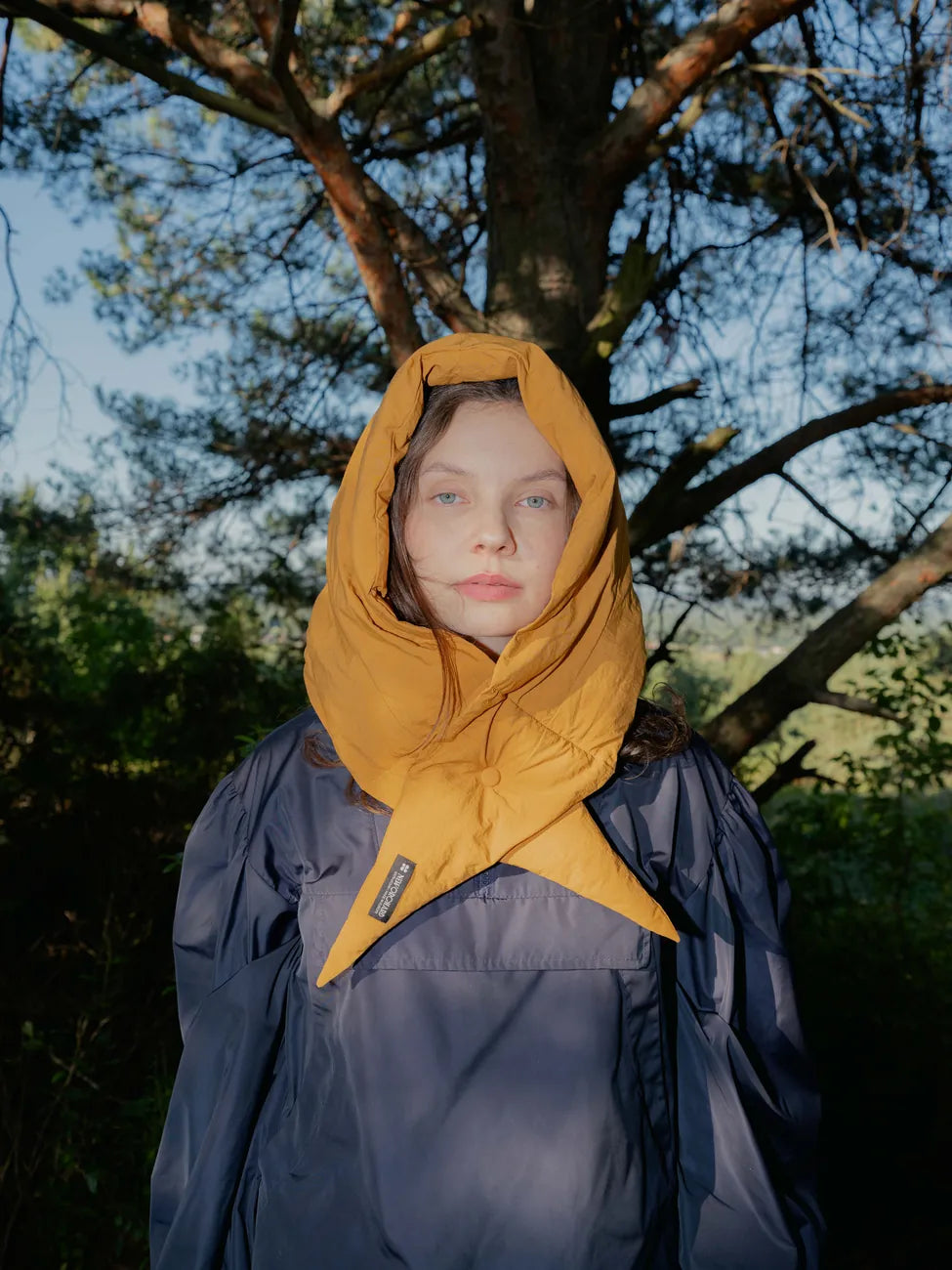 Amber yellow vegan winter capuche made from recycled materials, styled outdoors with a navy coat. - The New Orchard - Amber Yellow