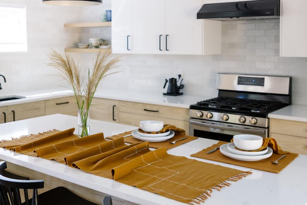Rift Valley table runner bronze with cocktail napkins and Semien placemats on a table