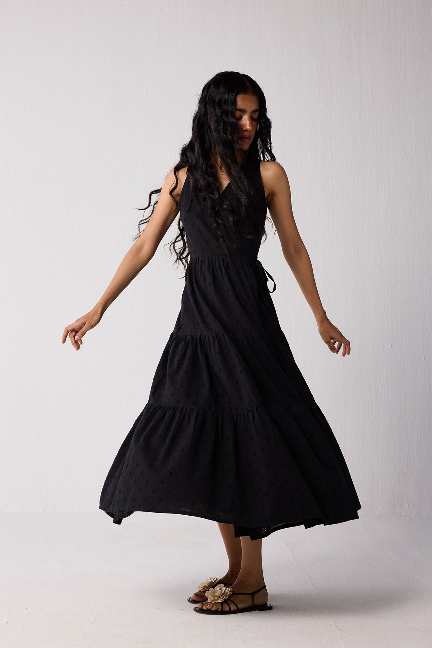 Woman wearing a black dress against a white background
