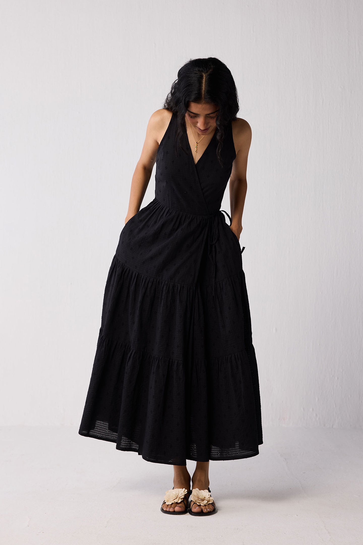 Woman wearing a black dress against a white background