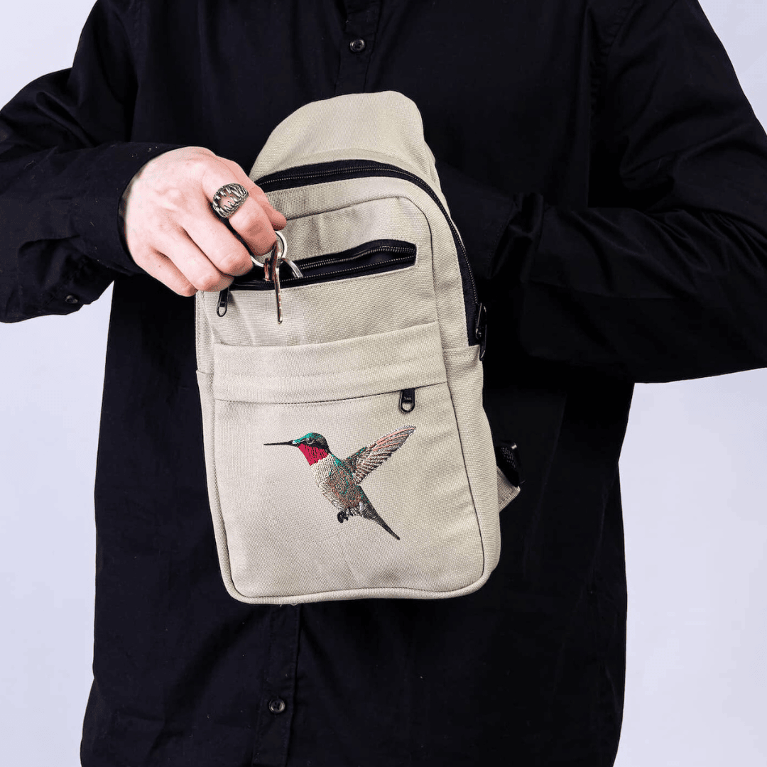 Umoja hummingbird canvas sling bag in sand white #color_sand-white