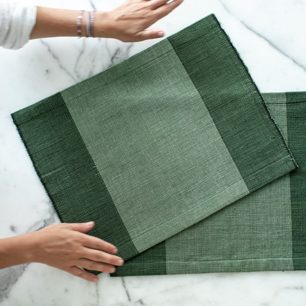 Two Sodo placemats in cedar on marble background