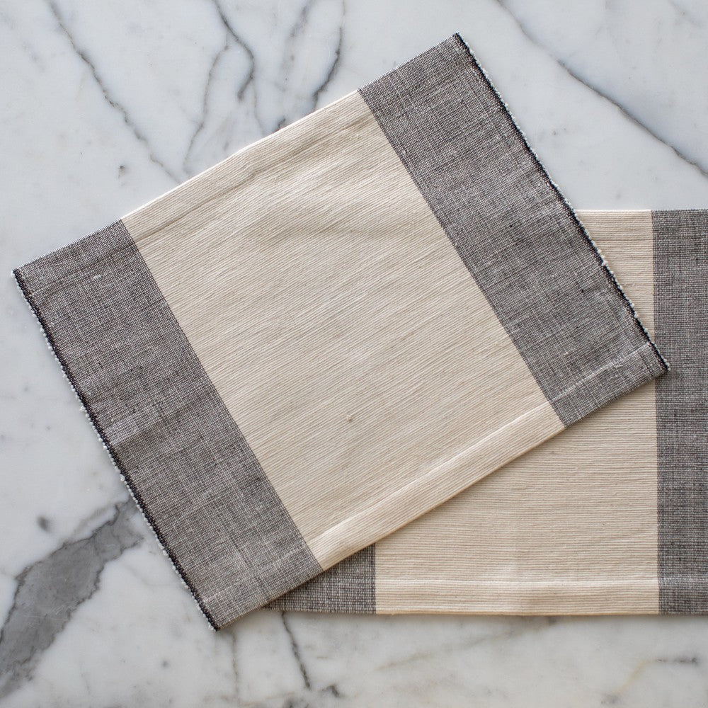 Two Sodo placemats in ivory on marble background