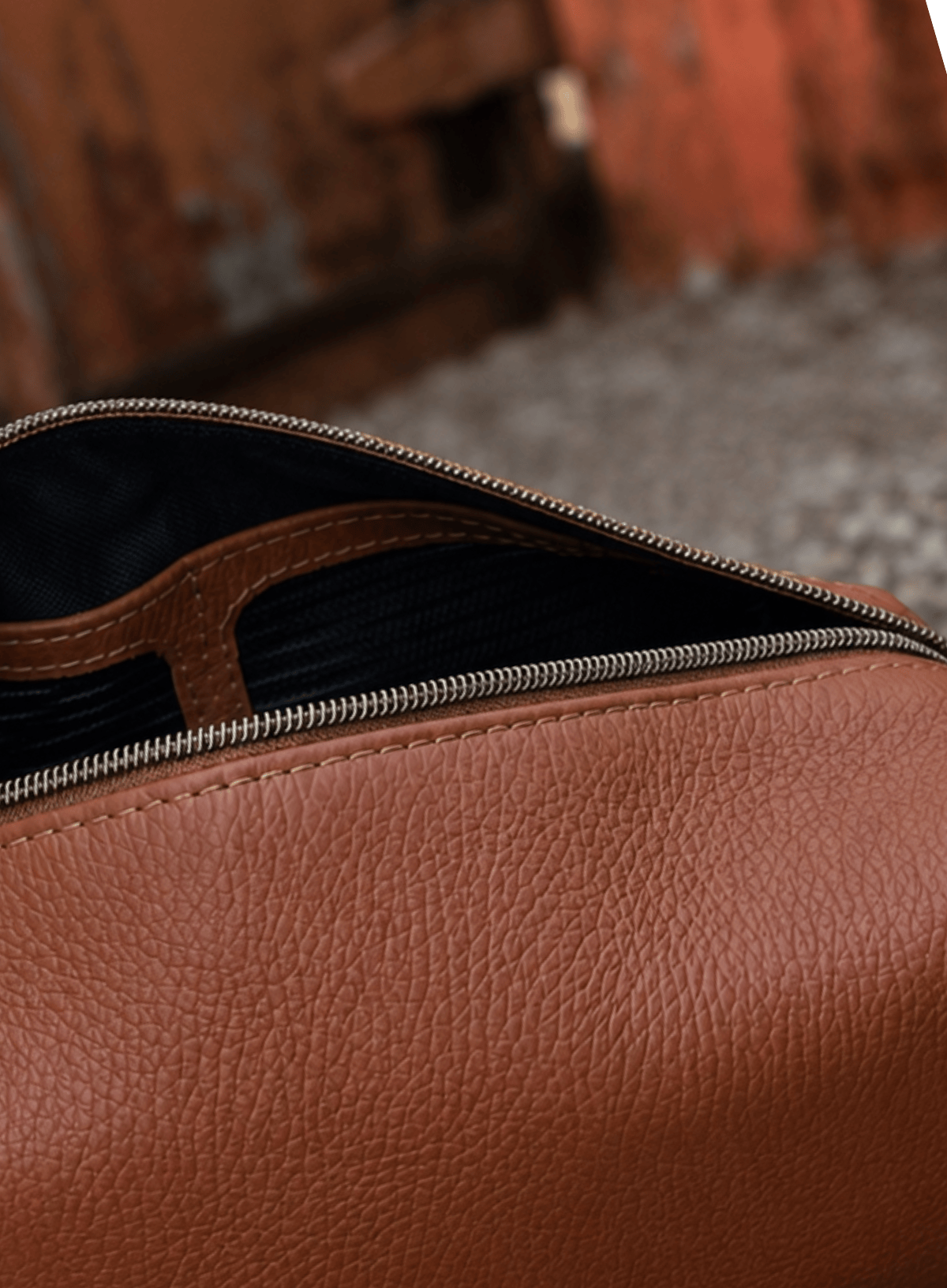Brown leather bag with a zipper on a blurred background