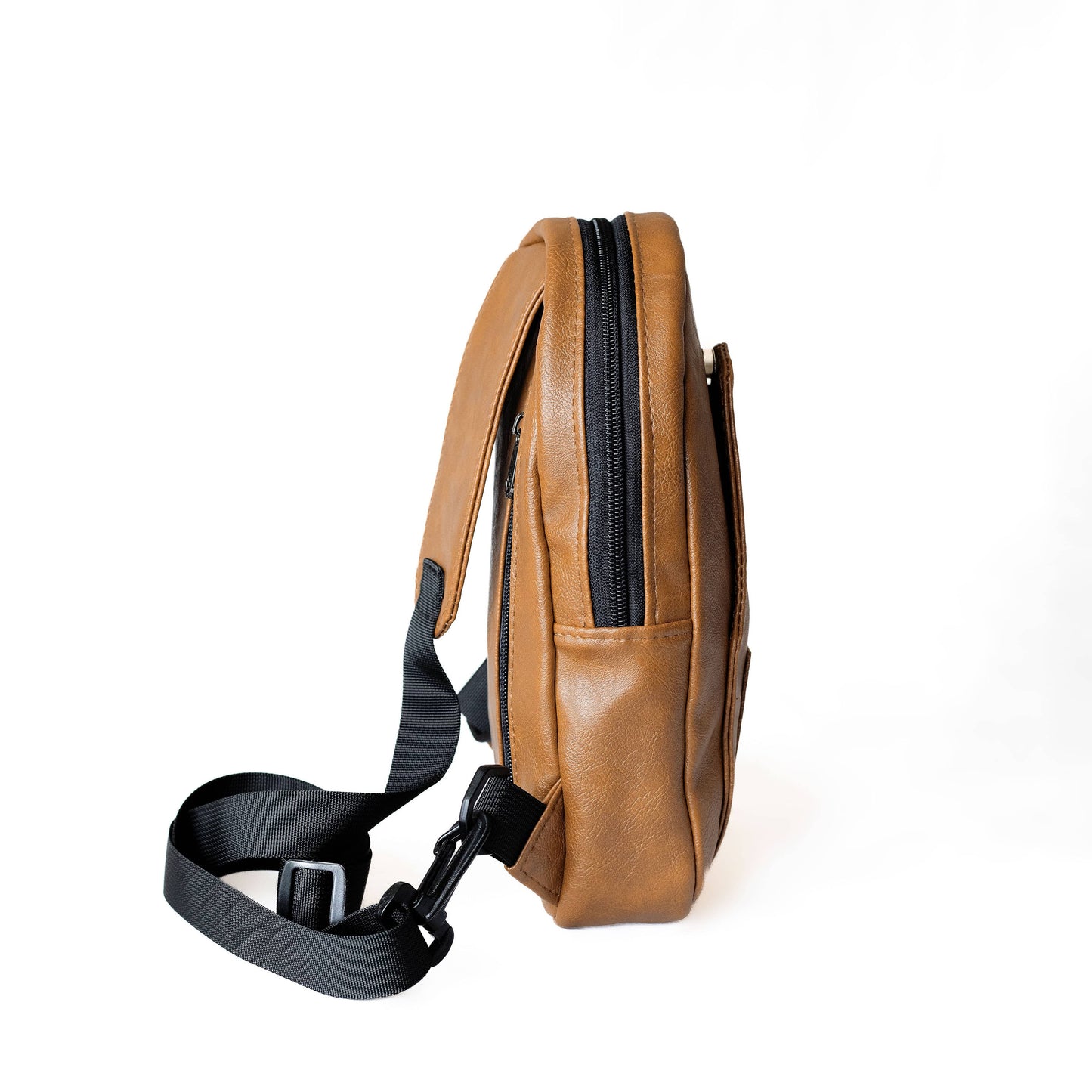 Buru dark tan vegan leather sling bag worn crossbody #color_dark-tan
