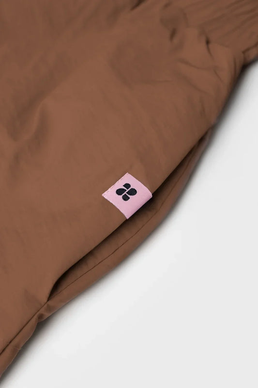 Brown vegan winter skirt with recycled materials tag and smooth fabric texture. - The New Orchard - Brown / S