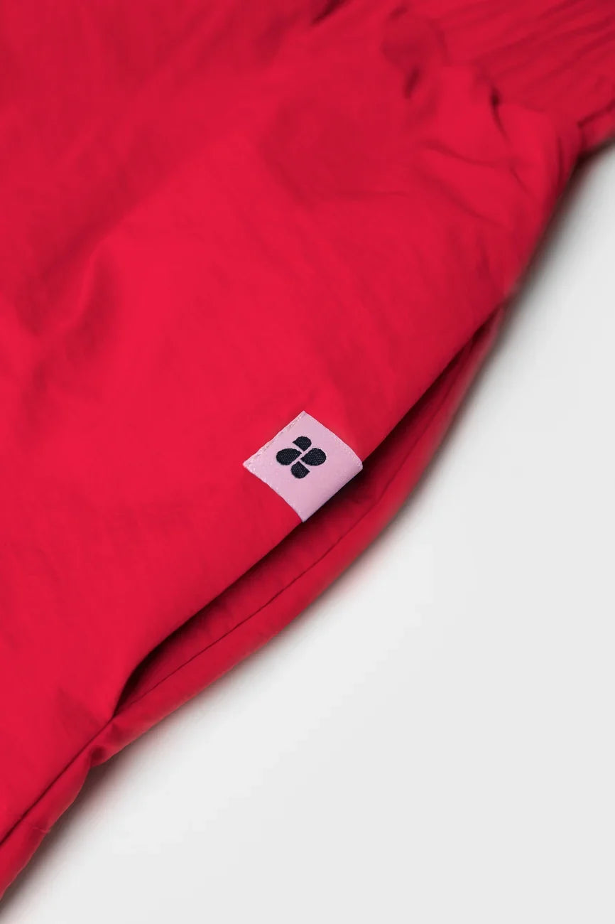 Red vegan skirt made from recycled materials with small black logo tag. - The New Orchard - Vivid Red / S