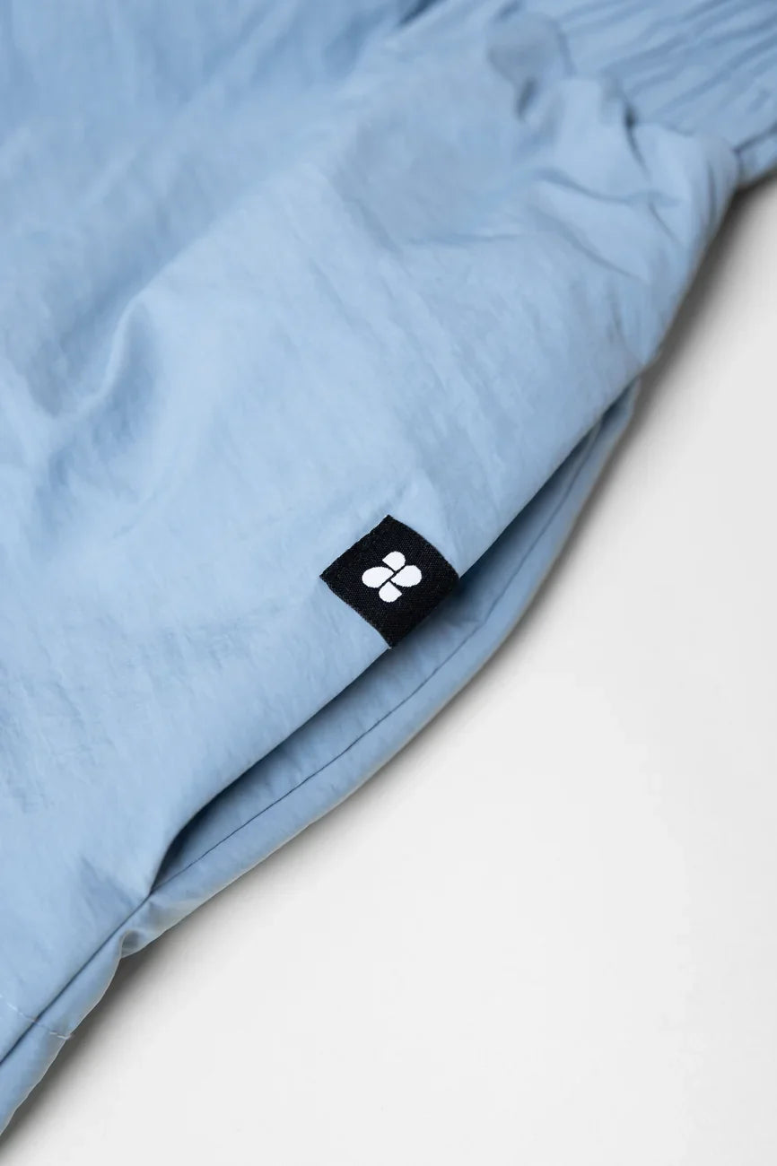 Sky blue winter vegan skirt made from recycled materials with black logo tag. - The New Orchard - Sky Blue / S